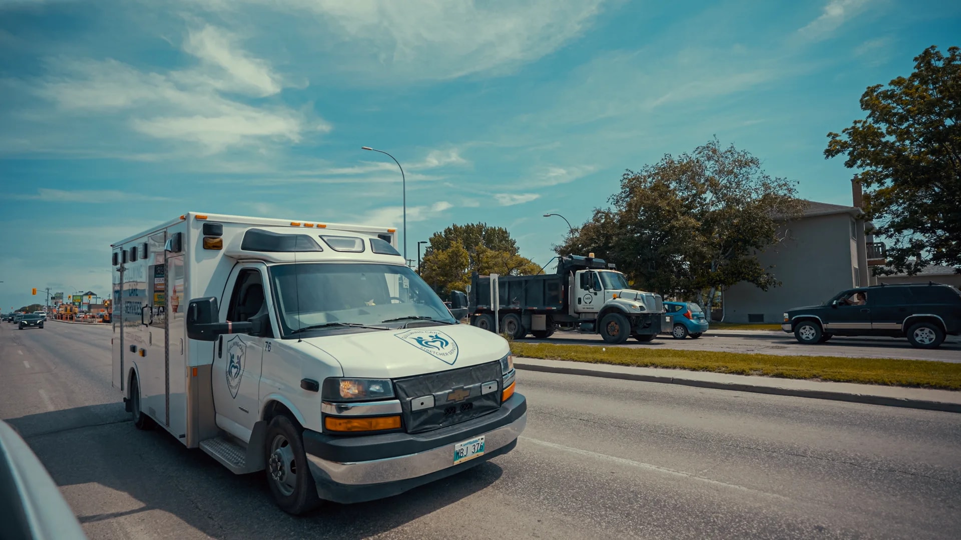 Gullwing Care stretcher vehicle travelling on a city road