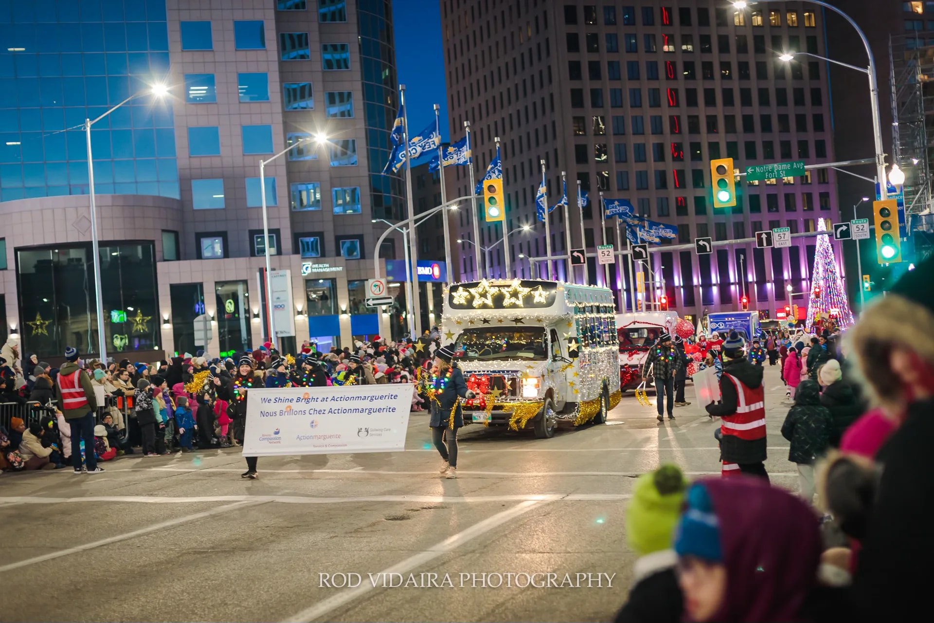 Maple Leaf Transit bus in a nighttime community parade