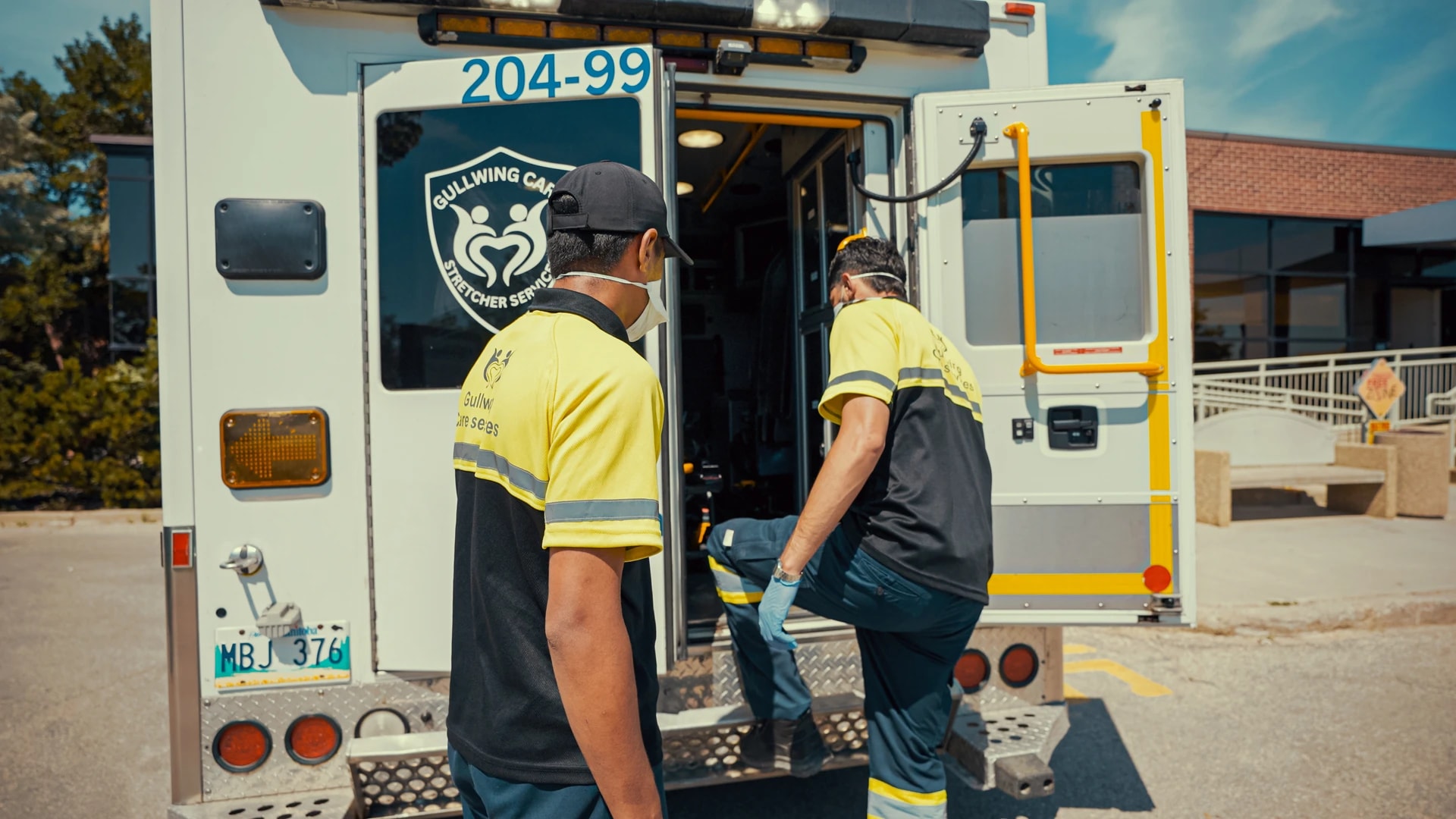Transport attendants at the rear of a Gullwing Care vehicle